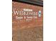 Weigewood Swim & Tennis Club signage on brick wall with designated parking and club number displayed at 9138 Babbitt Way, Charlotte, NC 28216