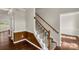 Inviting foyer with classic staircase featuring wood handrails and white spindles leading to the upper level at 9138 Babbitt Way, Charlotte, NC 28216