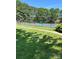 Well maintained tennis court with a blue surface and green surroundings at 9138 Babbitt Way, Charlotte, NC 28216