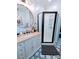 Bathroom featuring elegant vanity, round mirror, and a frameless shower enclosure at 101 Sunset Dr, Stanley, NC 28164