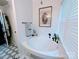 Bright bathroom featuring a soaking tub with black hardware and modern decor at 101 Sunset Dr, Stanley, NC 28164