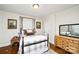 Cozy bedroom with a comfortable bed, hardwood floors, and natural light creating a serene atmosphere at 101 Sunset Dr, Stanley, NC 28164