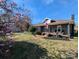 Home showcasing blooming magnolias and American flag, enhancing curb appeal at 101 Sunset Dr, Stanley, NC 28164