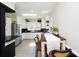 Eat-in kitchen with white cabinetry, black countertops, and stainless steel appliances at 101 Sunset Dr, Stanley, NC 28164