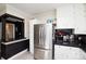 View of a modern kitchen with stainless steel appliances and contrasting black countertops at 101 Sunset Dr, Stanley, NC 28164