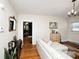Bright living room featuring hardwood floors, white walls, and a comfortable chaise lounge sofa at 101 Sunset Dr, Stanley, NC 28164