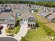 Aerial view of a beautiful two-story home with manicured landscaping, a two-car garage, and a welcoming front porch at 1017 Cheviot Ct, Waxhaw, NC 28173