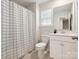 Well-lit bathroom featuring a shower with black and white curtain and a sink with vanity at 1017 Cheviot Ct, Waxhaw, NC 28173