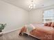 Cozy bedroom featuring a comfortable bed, soft lighting, and a large window at 1017 Cheviot Ct, Waxhaw, NC 28173