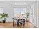 Bright dining area with large windows, hardwood floors, and elegant lighting, perfect for Gathering gatherings at 1017 Cheviot Ct, Waxhaw, NC 28173