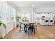 Sunlit dining area with modern table set, hardwood floors, and seamless flow into a well-appointed kitchen at 1017 Cheviot Ct, Waxhaw, NC 28173