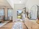 Inviting foyer with wood floors, a stylish console table, and a glimpse of the home's bright interior at 1017 Cheviot Ct, Waxhaw, NC 28173
