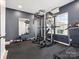 Home gym with squat rack, treadmill, dumbbells, mirror, and rubber flooring at 1017 Cheviot Ct, Waxhaw, NC 28173