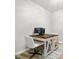 This home office features a rustic wood desk, computer, white walls, and bright natural light at 1017 Cheviot Ct, Waxhaw, NC 28173