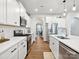 Modern kitchen with stainless steel appliances, white cabinets, and a functional layout at 1017 Cheviot Ct, Waxhaw, NC 28173