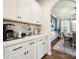 Clean countertops and white cabinets with an open archway, leading to the dining area at 1017 Cheviot Ct, Waxhaw, NC 28173