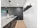 Stylish kitchenette with granite countertops, dark cabinets, modern lighting and stainless steel faucet at 1017 Cheviot Ct, Waxhaw, NC 28173