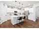 Modern kitchen with a center island, stainless steel appliances, and sleek countertops, ideal for entertaining at 1017 Cheviot Ct, Waxhaw, NC 28173