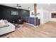 Open floorplan featuring living room and kitchenette with wood flooring and modern lighting at 1017 Cheviot Ct, Waxhaw, NC 28173