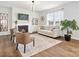 Cozy living room with a fireplace, built-in shelves, neutral decor, and lots of natural light at 1017 Cheviot Ct, Waxhaw, NC 28173