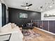Stylish living room featuring wood floors, white couch, black accent wall and modern lighting at 1017 Cheviot Ct, Waxhaw, NC 28173