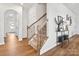 Bright staircase with wooden handrails and decorative iron spindles leading to the upper levels of the home at 1017 Cheviot Ct, Waxhaw, NC 28173
