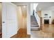 Carpeted stairs lead to the lower level that includes a fireplace and room for entertaining at 11296 Serenity Farm Dr, Midland, NC 28107