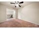 Open loft space with neutral carpet and wrought iron railing at 113 Burlingame Ct # D, Mooresville, NC 28117