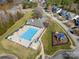 Aerial view of a community pool, playground, and surrounding green spaces at 113 Burlingame Ct # D, Mooresville, NC 28117