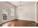 Light-filled dining room with hardwood floors and a modern chandelier at 113 Burlingame Ct # D, Mooresville, NC 28117