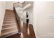 Foyer with hardwood floors, staircase, and open view to the kitchen at 113 Burlingame Ct # D, Mooresville, NC 28117