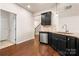 Kitchen boasts stainless steel dishwasher, dark cabinets, and hardwood floors at 113 Burlingame Ct # D, Mooresville, NC 28117
