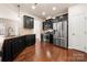 Modern kitchen features stainless steel appliances, dark cabinetry, and hardwood floors at 113 Burlingame Ct # D, Mooresville, NC 28117