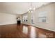 Bright living room featuring a fireplace, chandelier, and hardwood floors at 113 Burlingame Ct # D, Mooresville, NC 28117