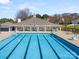 Community pool with a large pool house, chairs, and covered seating areas at 113 Burlingame Ct # D, Mooresville, NC 28117