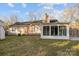 Charming home featuring an enclosed sunroom and a large backyard, ideal for relaxation at 11501 Candlelight Ct, Charlotte, NC 28226