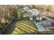 Aerial view of a fenced backyard featuring a sunroom addition and storage shed at 11501 Candlelight Ct, Charlotte, NC 28226