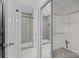 Dual view of a bathroom featuring a tiled shower and a walk-in closet with wire shelving at 11501 Candlelight Ct, Charlotte, NC 28226