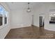 Elegant dining room with modern lighting, hardwood floors, and adjacent kitchen, ideal for Gathering meals at 11501 Candlelight Ct, Charlotte, NC 28226