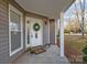 Inviting front entrance featuring a decorative wreath, charming decor, and a welcoming ambiance at 11501 Candlelight Ct, Charlotte, NC 28226