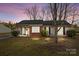 Charming single-story home with a well-maintained lawn and a welcoming entrance, showcasing curb appeal at 11501 Candlelight Ct, Charlotte, NC 28226