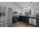 This kitchen features stainless steel appliances, granite countertops, and two-tone cabinets at 11501 Candlelight Ct, Charlotte, NC 28226