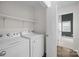 A laundry room features shelving, and is equipped with a washer and dryer at 11501 Candlelight Ct, Charlotte, NC 28226