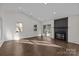 Spacious living room boasts a sleek fireplace, hardwood floors, and large windows offering ample natural light at 11501 Candlelight Ct, Charlotte, NC 28226