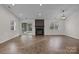 Open living room features hardwood floors, a modern fireplace, and bright windows, perfect for entertaining at 11501 Candlelight Ct, Charlotte, NC 28226