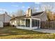 Cozy home with a spacious sunroom and a well-maintained backyard perfect for outdoor enjoyment at 11501 Candlelight Ct, Charlotte, NC 28226