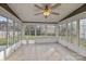 Bright sunroom with tile floors and many windows offering backyard views at 11501 Candlelight Ct, Charlotte, NC 28226