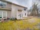 Exterior back of home with small patio and mossy lawn at 12601 Tucker Crossing Ln, Charlotte, NC 28273