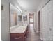 Bathroom with double vanity, gray vinyl floors, and multiple lights at 12601 Tucker Crossing Ln, Charlotte, NC 28273