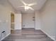 Bright bedroom featuring new floors, ceiling fan, and gray walls at 12601 Tucker Crossing Ln, Charlotte, NC 28273